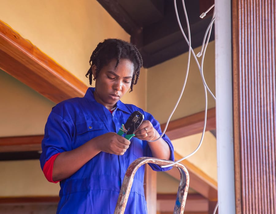 Electrician hardwiring a smoke alarm in Christchurch